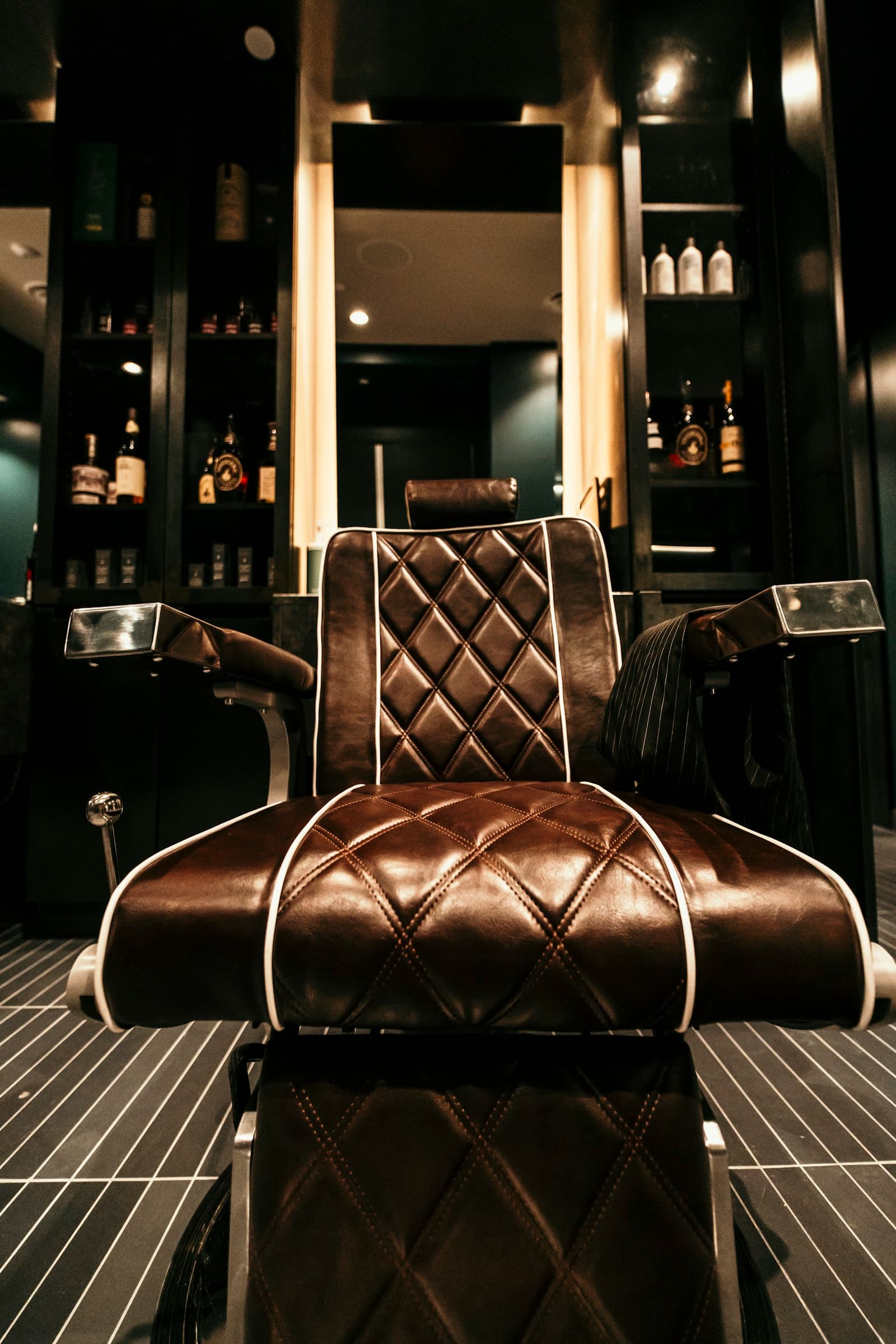 A quilted leather salon chair in warm light